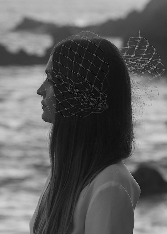 Model wears Ivory Bird Cage Veil with Bow for her summer wedding