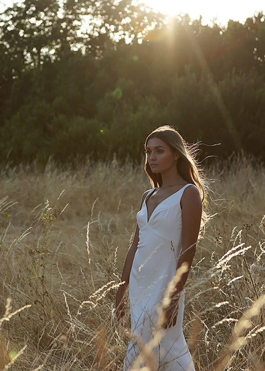 Bride wears V-neck fit and flare gown in outdoor summer wedding