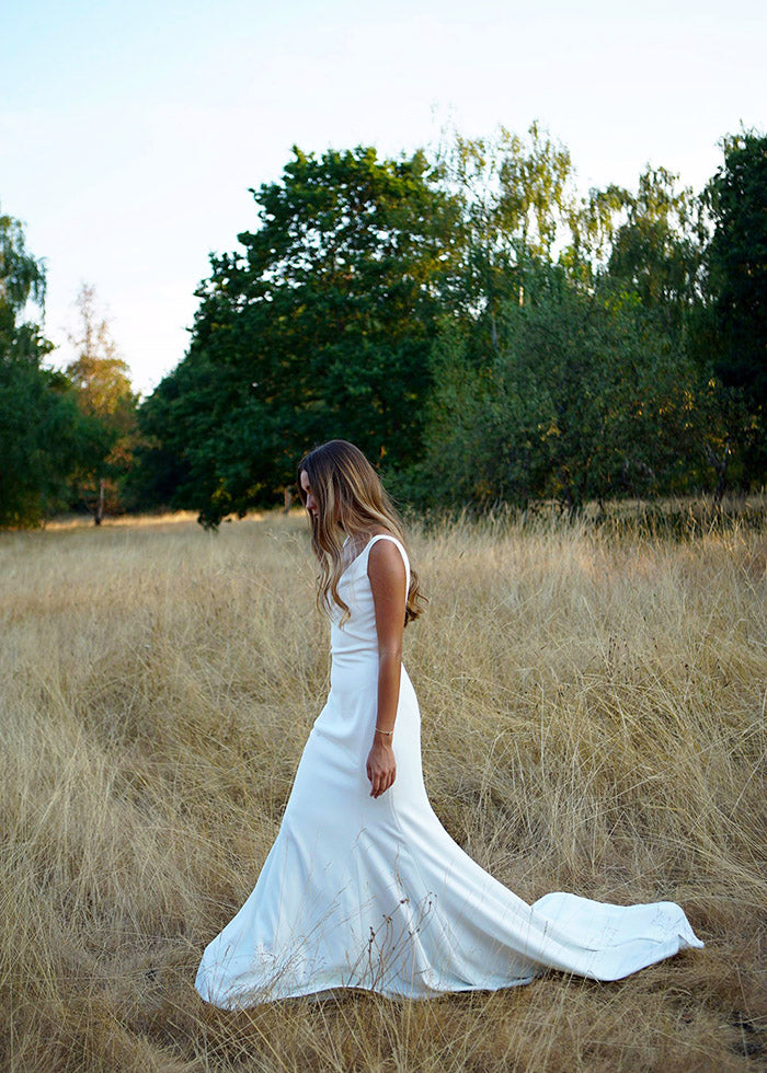 Simple elegant ivory fit and flare v-neck wedding dress designed by best wedding designers for summer weddings