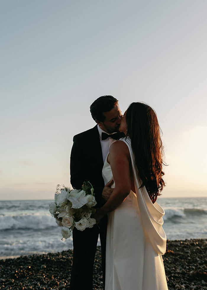 Satin cowl details as worn by bride for her summer beach wedding 
