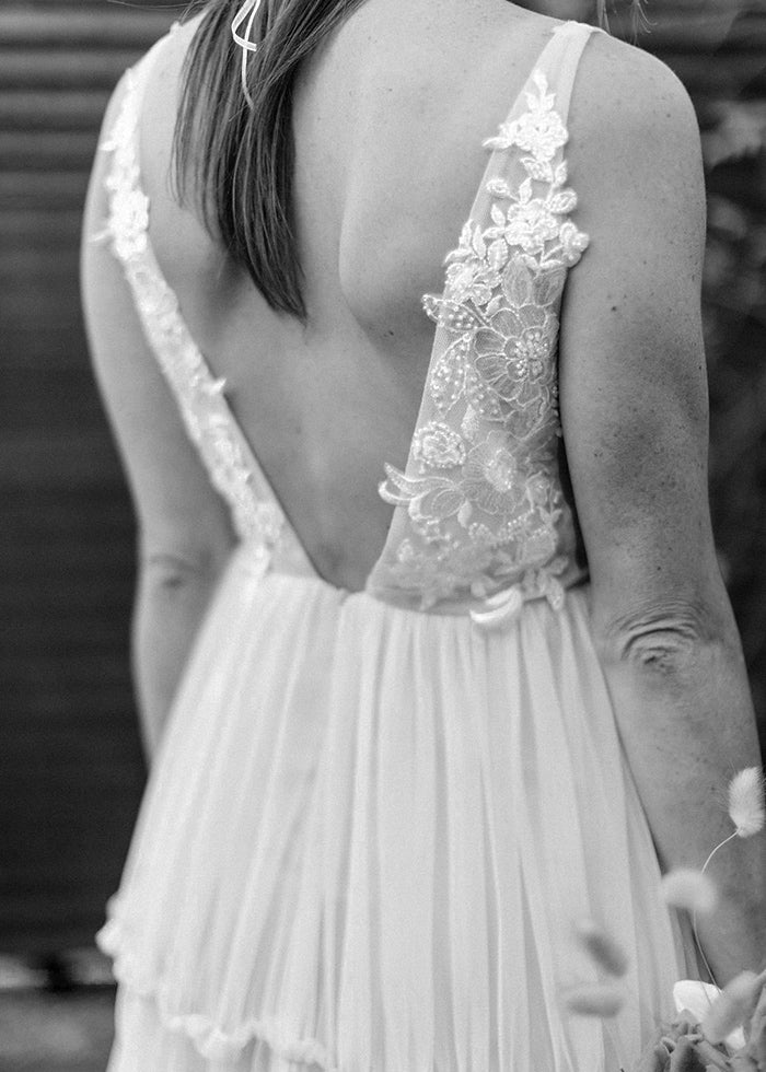 Deep v-neckline beaded lace and soft tulle wedding dress custom designed by best wedding designers in London