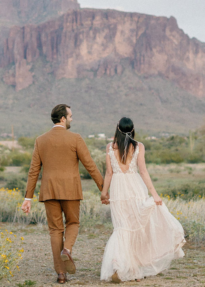 Bride shows off deep v-neckline tulle and lace details on her custom designed wedding dress