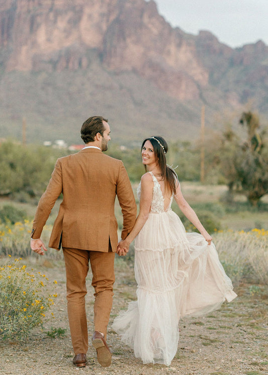 Bride wears Champagne tulle deep v-neckline wedding dress at outdoor summer wedding