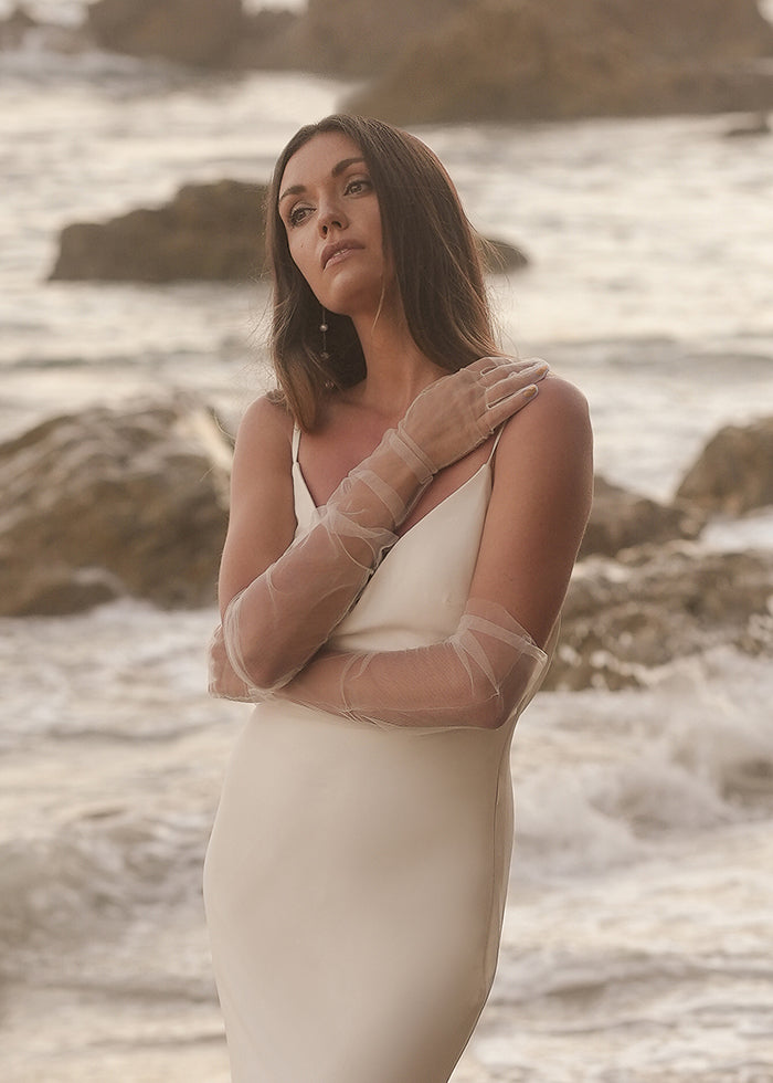 Model wears tulle opera gloves on beach for Summer weddings